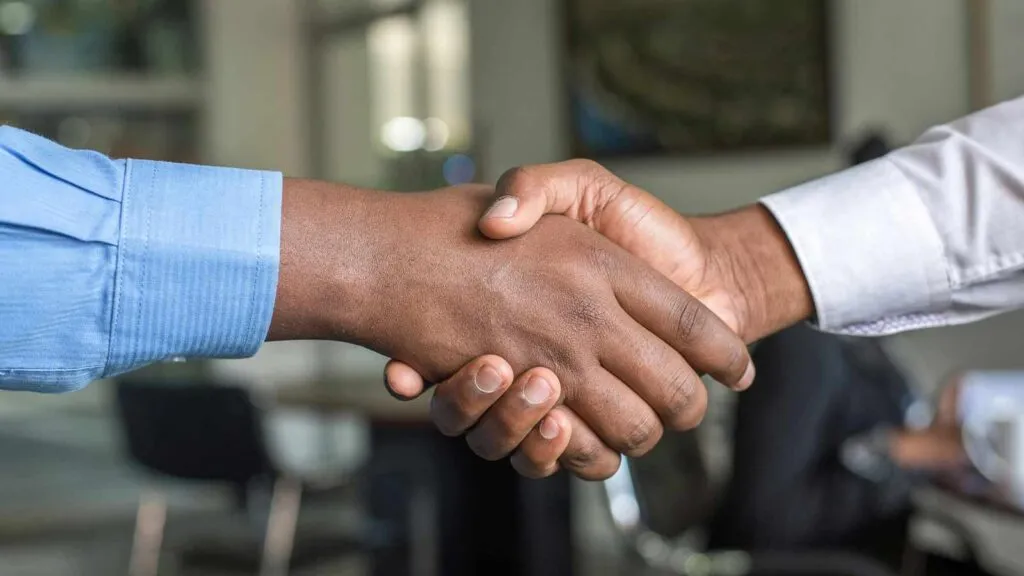 close-up of a handshake of a man and woman property deed abstract of title title abstractor