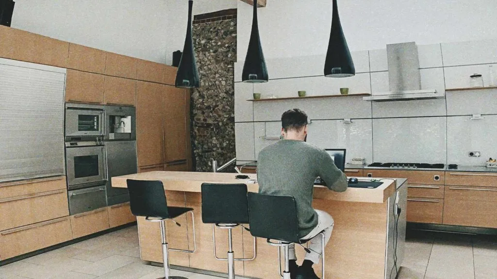 a man sitting at a table with a laptop mortgage lien lien release chain of title title search company title abstractor title search services mineral rights search title update property title search